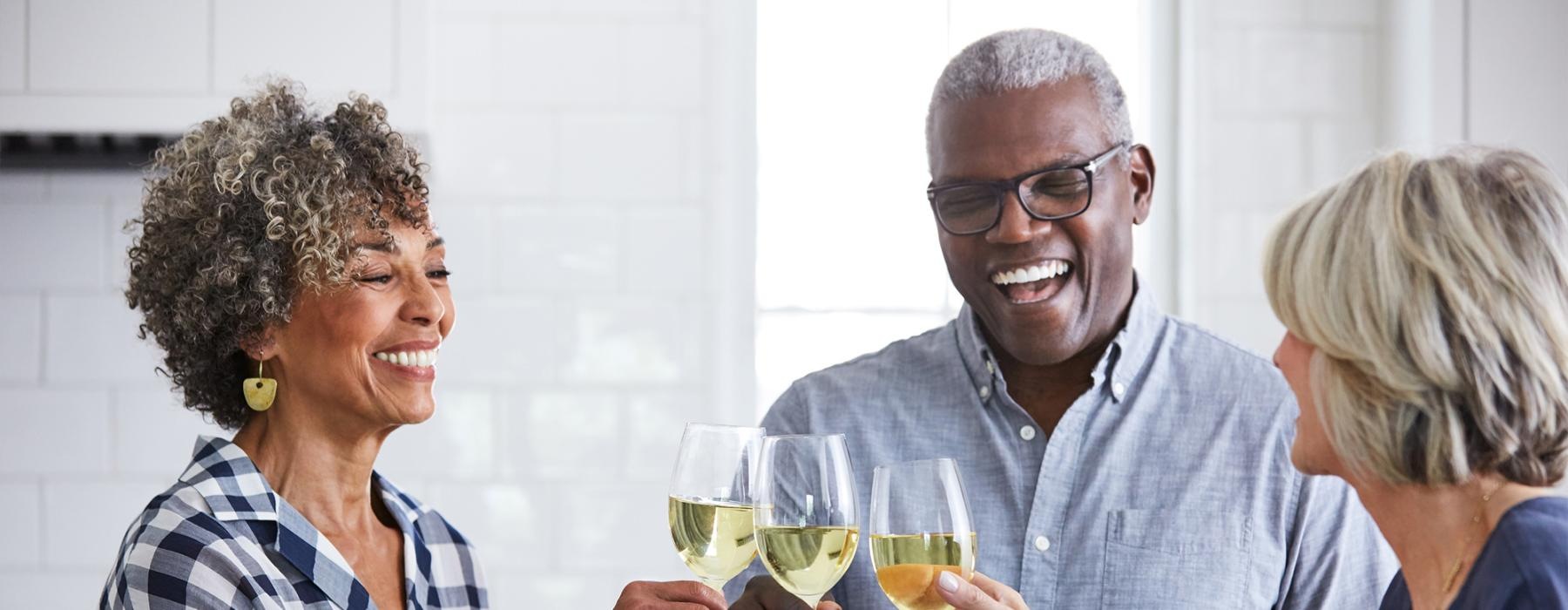 a few people toasting wine glasses